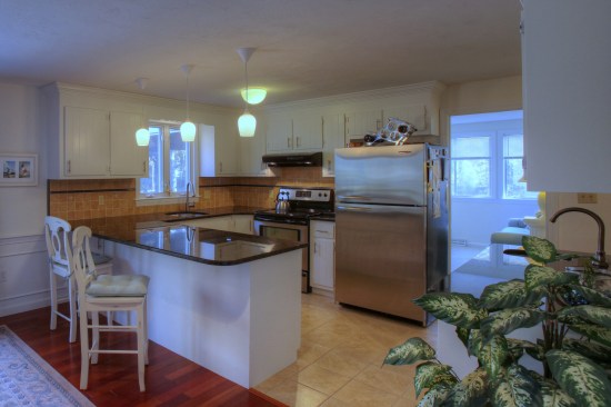 A flush-mount light in the center of the kitchen can work in concert with
pendants over a peninsula.