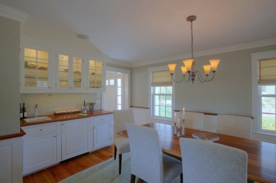 Lighted glass-front cabinets show off glassware.