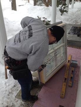 A bead of low-temperature caulk applied around the opening will seal the window flange against the house.