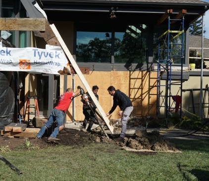 Two-by lumber extensions (nailed in an “L” shape to keep them straight and stiff) projected the line of the rafters to guide the installation of the helical piers, which were drilled at the same angle as the pitch of the roof. 