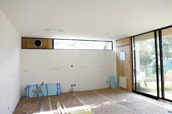 Heat-pump ducts are run through temporary window openings.
