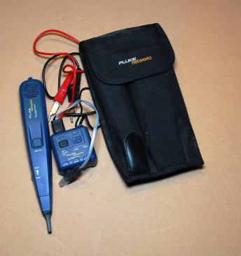 This is my favorite tool in the kit. I can connect the toner to the end of a wire (with alligator clips or by plugging it into a RJ45 jack) and use the probe (the pen-like device) to get a rough approximation of where the wire runs inside the wall. The probe will emit a tone when it gets close to where the wire is. This comes in handy when the sheetrockers cover up boxes by accident. You can identify a wire in a remote location by connecting the toner to one end of the cable and then passing the probe over the other end. The probe will emit a distinct tone when its tip is at the correct wire.