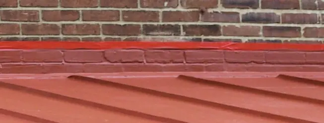Because it is self-flashing and bonds to a variety of materials, Hydrostop provides seamless coverage between the addition's roof and the brick wall of the main house.