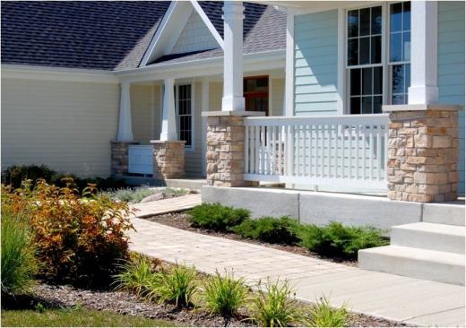 An ultra-low–profile ramp leading up to the front entrance is cleverly disguised by landscaping and a front porch.