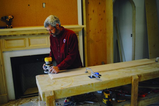 Upper section pieces. Construction begins with rabbeting the vertical pieces for the upper cabinet, using a router.