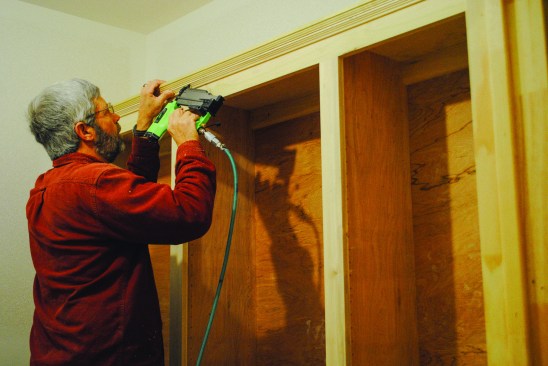 The author uses a cove-and-bead bit to make a two-step trim detail on the top of the upper cabinet. Short pieces of molding finish the back edge of the seat, and the cabinets are ready to be sanded and painted.