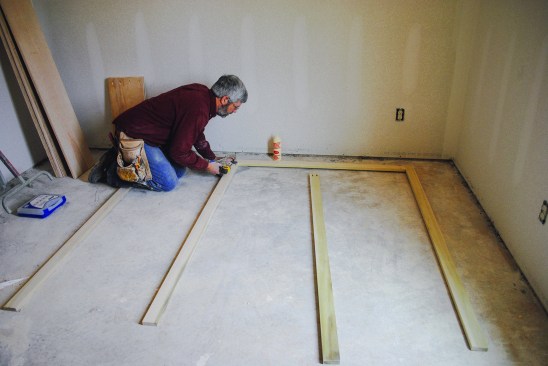 Build the upper section. Working in a large, flat area, the author drives pocket screws to assemble the face frame for the upper section.