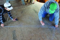 The crew darkens the rafter lines so that they can see the cut details where they intersect at the ridge.