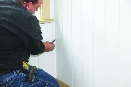When scribing material to close a wider gap such as at the end of this wall paneling, use a compass scribe that can be opened to the desired width.