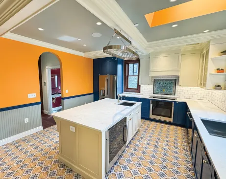 The kitchen blended modern, energy-efficient appliances with Victorian-inspired finishes and colors. 
