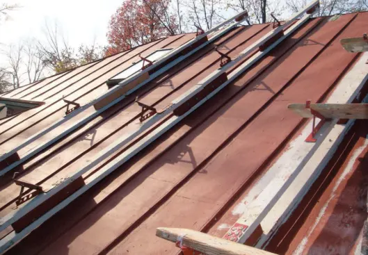For easy movement over the roof, the installers used ingenious roof-bracket assemblies that hooked over the ridge.