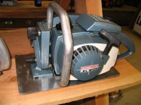 This saw is in better shape than the last one. The photo was provided by Wayne Sutton, the owner of Wayne's Chainsaw Museum in Amboy, OR. From the back side it's evident that this is a chainsaw with a baseplate added and the bar removed.