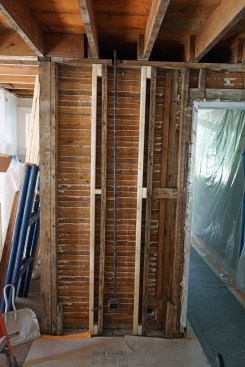 This bearing wall section currently has little support, and will bear on the new I-beam to be installed in the basement. The studs in this critical wall section had bowed and required reinforcement with new studs before any jacking could be done.