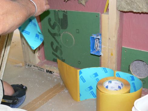 The cut-out circles made when the holes were drilled into the ZIP sheathing patches were replaced as plugs for the holes, then the disks were sealed using squares of Pro Clima Uni Tape (www.foursevenfive.com).
