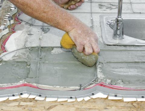 Spreading the mortar with a sponge