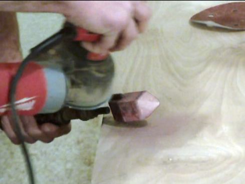 After shaping the tip’s facets with the grinder, we sand them using an orbital sander with 80-grit paper to get some of the rough burrs off. Then, switch to 100 to 120-grit to get a smooth surface.