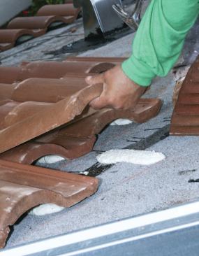 Setting roof tiles in the adhesive foam.