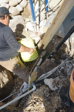 Once the pier was driven, a section of the waste line was replaced. Backfilling was done by hand to avoid dislodging the repaired pipe section.