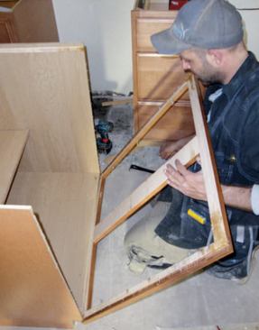 The author ordered face-frame and door assemblies sized to fit vanity cabinets and in a finish that matched the kitchen cabinets.