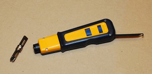 When you connect wires to jacks or terminal blocks you punch them down between a pair of bars that slice through the sheathing and make electrical contact.. If you buy a blister pack of data jack ends at a big box store the package will include a little plastic punch down tool. That free tool is nothing like this one. Sometimes I really gotta’ give it some pressure and the larger handle is more manageable. The business end that you see out of the handle in the photo stores in the butt of the handle to keep it protected when stowed in your bag. I like that the tool is spring-loaded and automatically trims the wire (to length) when you punch it down.
