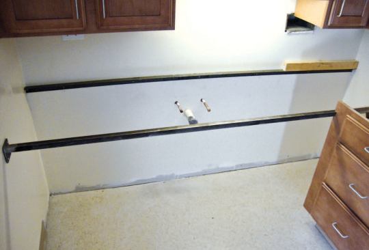 The sink countertop is supported by steel angle at the wall and bar stock at the front.