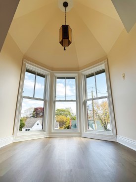 The re-created house features a finished attic that elegantly incorporates the rooftop turret.