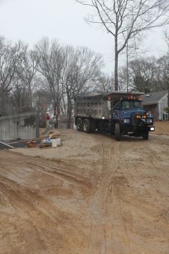 ... 10-wheeler dump trucks loaded with the fill needed on the site.