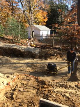 A crucial part of reconfiguring the lot is creating a driveway up to the main floor of the house for accessibility. After removing the poor soils, George puts down clean structural fill in 6-inch lifts, compacting each layer as he goes. The driveway is also needed to support heavy construction vehicles such as the concrete pump truck and…
