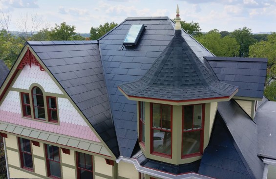 The turret is roofed with laminated shingles that blend well with the Tesla Solar Shingles.