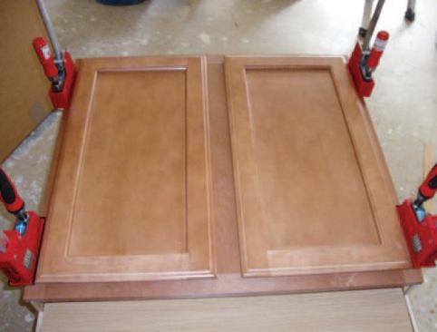 The face frames and doors were applied  to stock boxes that had been modified to fit under a 34-inch-high countertop.