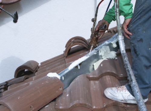 Under South Florida's upgraded codes, hip tiles must be attached to a metal reinforcing channel, which is nailed to the deck.