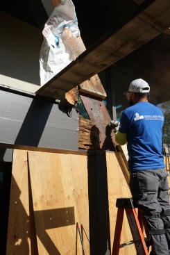 A strong field weld requires clean surfaces free from rust and paint. Prior to installing the columns, a worker used a grinder to clean the surface of the existing flitch plates. 