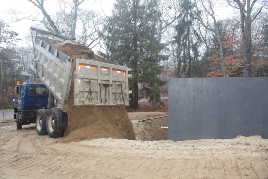 Because so much of the soil from the excavation was unusable because of poor drainage qualities, 400 yards of material need to be brought in for fill purposes.