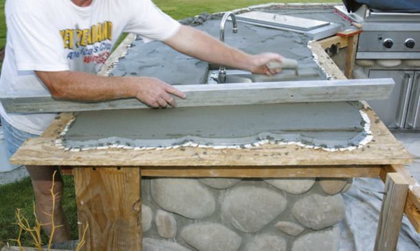 While the surface of the thinset was still moist and tacky, I spread and compacted latex deck mud over the top, then used a straightedge and trowel to remove the excess.