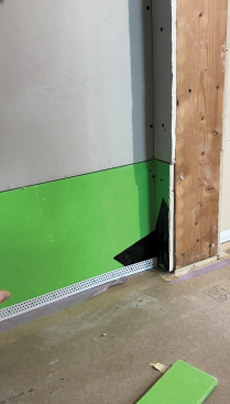 TrimTex L-bead is installed along the wall.