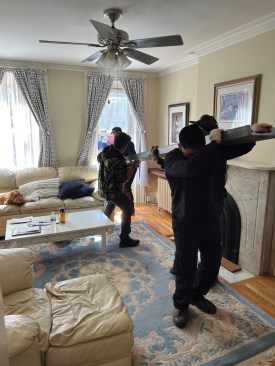 With no way to crane the steel where it's needed, carrying them through the house was the only option.