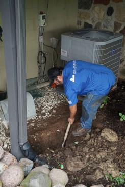 Excavation in preparation for drilling helical piers was done by hand to carefully work around utilities.