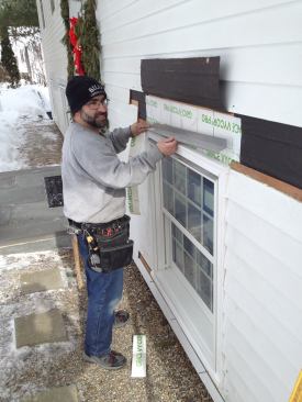 Per the manufacturer’s instructions, a second layer of drip cap is installed over the molding.