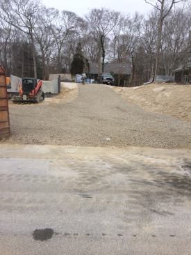 The last item on the rough-out list is putting in a temporary crushed-stone driveway for the construction vehicles. The stone also makes a clean, even surface to stage construction materials.