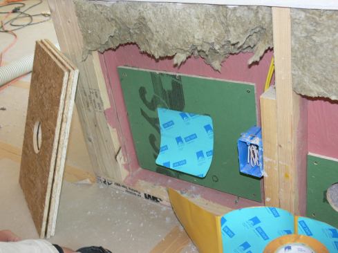 A Pro Clima self-adhesive membrane piece in place to seal the insulation hole in a ZIP System patch in the double wall.