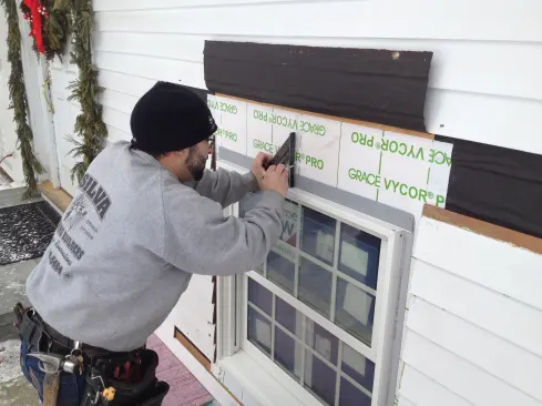 A mark in the center of the window and one in the opening allows Manny to center the window from the outside.