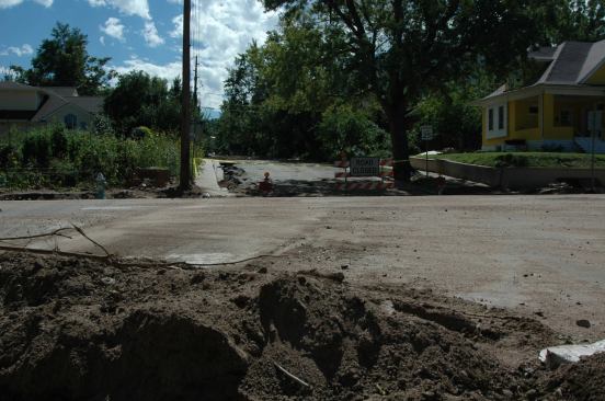 After the flood waters subsided, plows were brought in to clear the streets. Mounds of sandy soil and rocks lined the streets throughout Boulder and in many areas, the sediment was piled more than a foot deep on the right-of-way between the street and sidewalk.
