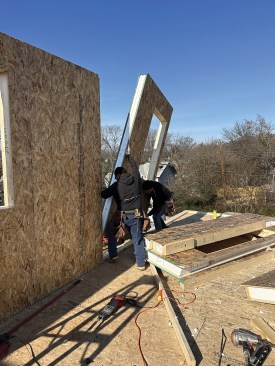 The Queen of Zero framing crew installs one of 90 structural insulated panels (SIPs) for the home’s walls.