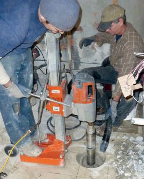 Once the floor was mapped, plumbers drilled holes in the slab to move supply and DWV lines to their new locations.