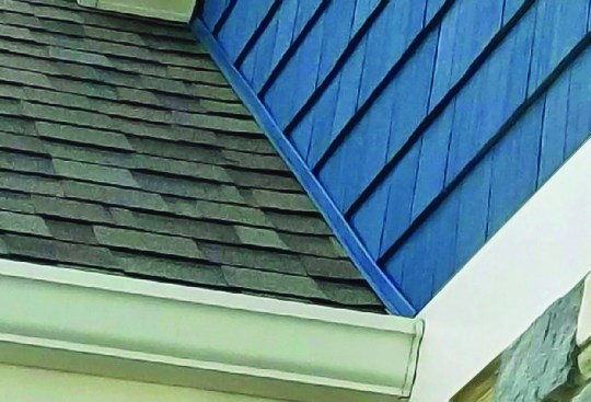 It turned out that the bottom channel on the vinyl siding above the roof was acting like a tiny gutter.