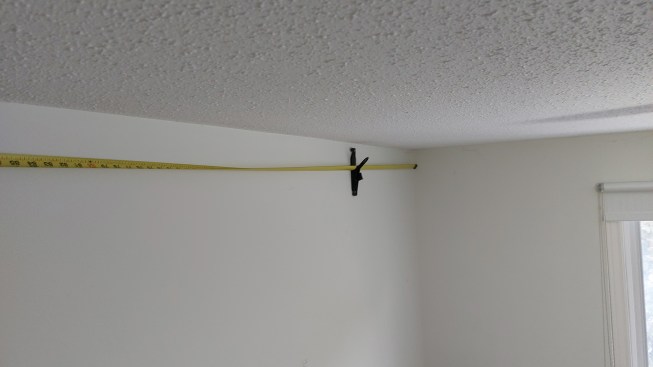 A crown molding hanger is an inexpensive way for someone to hold up crown while working alone. Beyond just holding crown up during install, the hanger is handy for taking longer measurements.