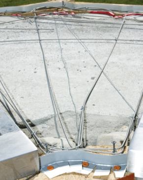 To prevent the forms and screeds from spreading while I compacted the mortar bed, I also used tie wire to draw the opposing sides together, running it beneath the reinforcing rods.