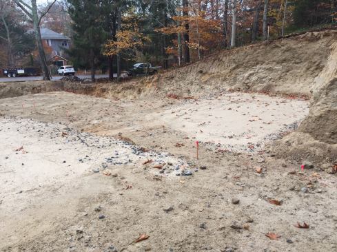 With the side of the lot cut away for the foundation, the steep slope is clearly visible.