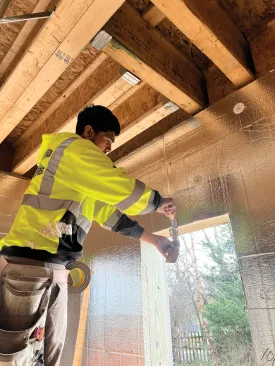Crew members work on air-sealing the foundation walls.