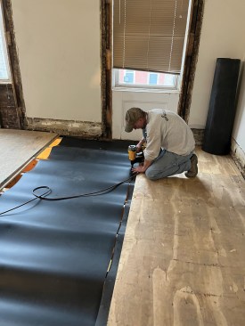 The MLV sheet is nailed in place to the top of the joists.